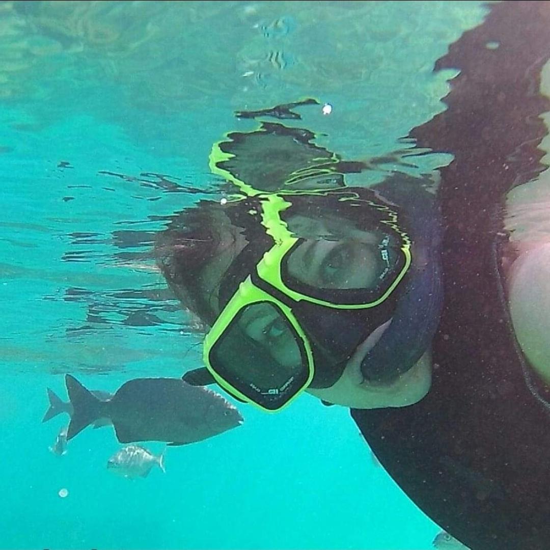 girl underwater in a mask and gear 