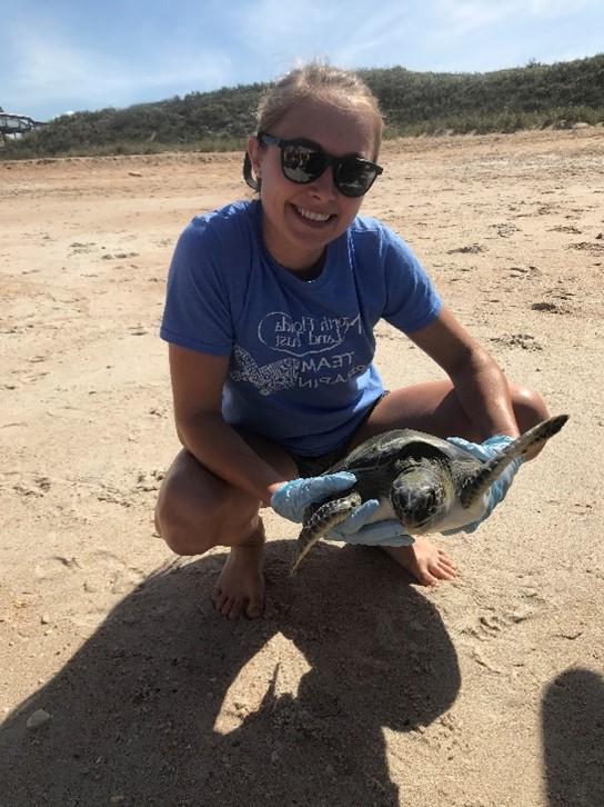 girl smiling with turtle